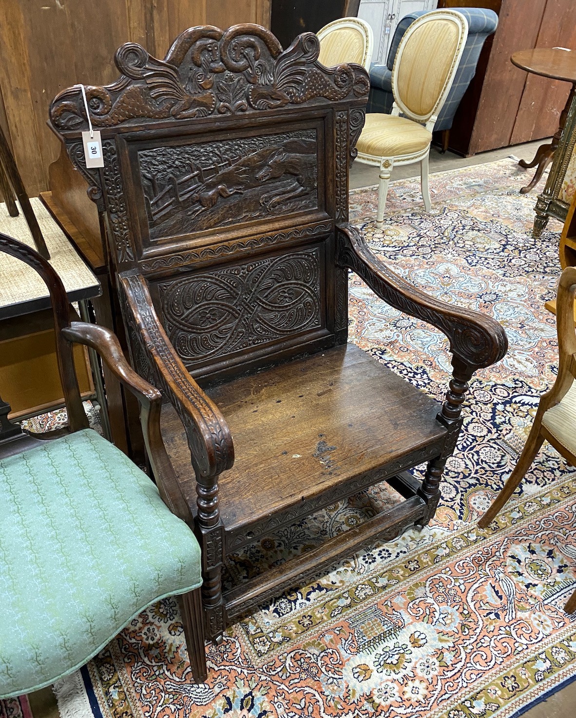 An 18th century and later carved oak wainscot chair, width 77cm, depth 65cm, height 120cm